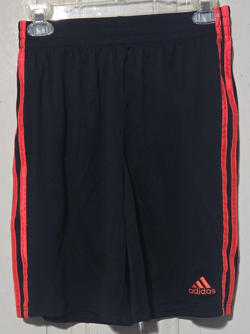 Adidas Kids Black Athletic Shorts with Red-Orange Side Stripes